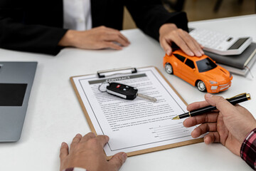The renter is signing a car rental agreement with the car rental company. After discussing the...