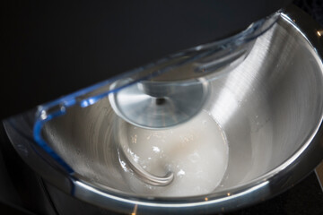 Water and yeast spinning in a bowl for baking.