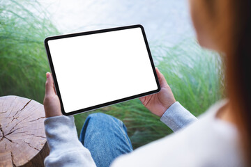 Mockup image of a woman holding digital tablet with blank white desktop screen