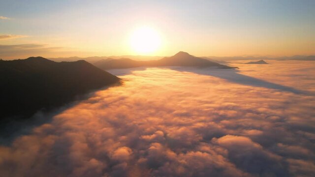 4K Aerial video Beautiful sunrise above dense clouds and fog in the morning, Cinematic drone shot.