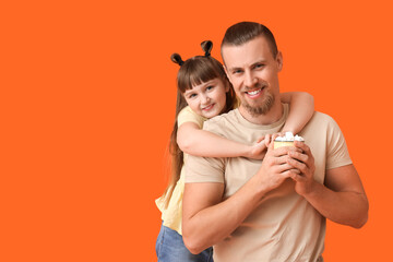 Happy daughter and father with cup of hot cocoa on color background