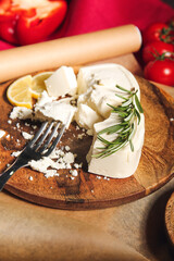 Plate with crushed feta cheese on grunge background