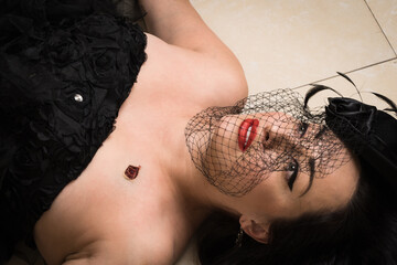 Noir film. Dead woman in a vintage interior. She was shot in the chest.