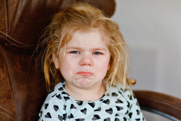 Cute adorable crying sad toddler girl. Little angry sleepy baby girl at home. Horrible terrible 3...