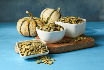 Bowls with pumpkin seeds on table