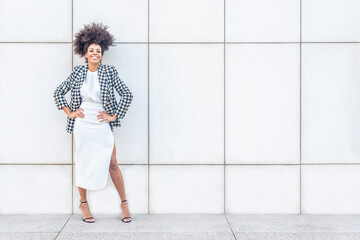 african woman posing in a white dress and smiling