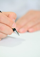 Business man's hand holding white paper and pen with copy space