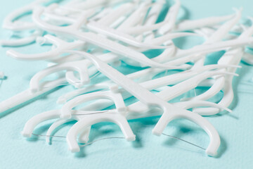 Close-up flossing toothpicks on the blue background
