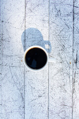 Black coffee in a coffee cup top view collection. black coffee without sugar A white cup was placed on a white wooden table, shadowed by the soft sunlight.