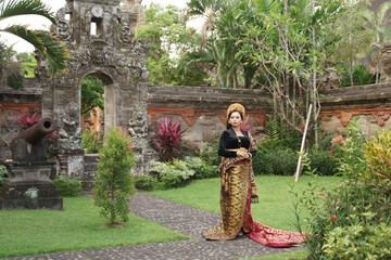 Woman wearing Balinese Kebaya in a traditional Balinese garden