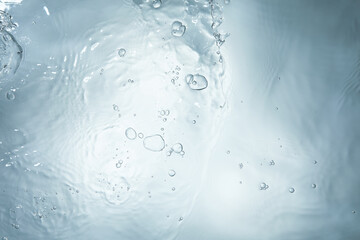 blue water surface with bubbles and waves ripples back lighting 