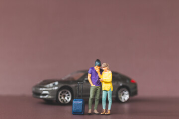 Miniature people Couple looking at their smartphones for planning a trip. Travel and Adventure concepts