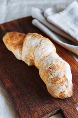 Artisan sourdough bread on wooden cutting board. Selective focus