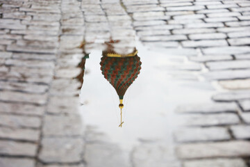 Moscow Red square during rainy weather. Reflection of St. Basil's Cathedral in a puddle of water on...
