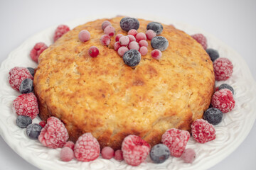 Banana pie with berries on a white background