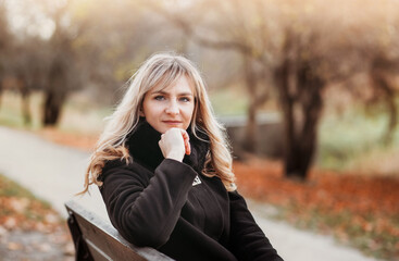 Autumn woman in autumn park. Warm sunny weather. Fall concept