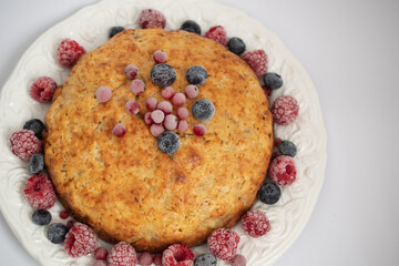 Banana pie with berries on a white background