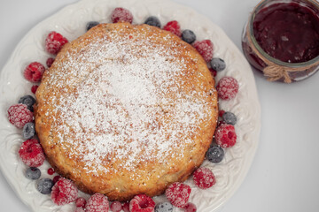 Banana pie with berries on a white background