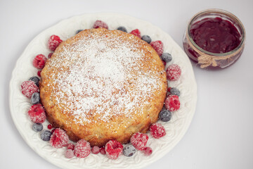 Banana pie with berries on a white background