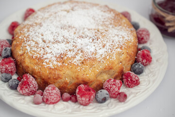 Banana pie with berries on a white background