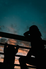 Silhouette of mother and daughter in the sunset