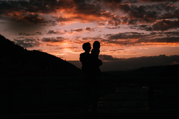 Silhouette of father and daughter in the sunset