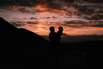Silhouette of father and daughter in the sunset