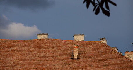 chimney on the roof of the house against the blue sky