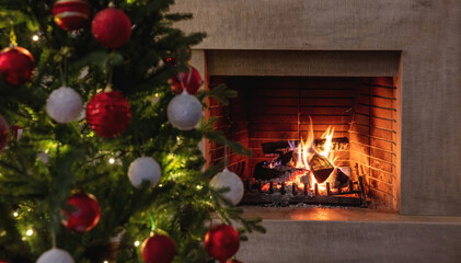 Christmas holiday home background. Warm cozy burning fireplace and Xmas tree decoration