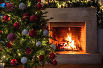 Christmas holiday home background. Warm cozy burning fireplace and Xmas tree decoration