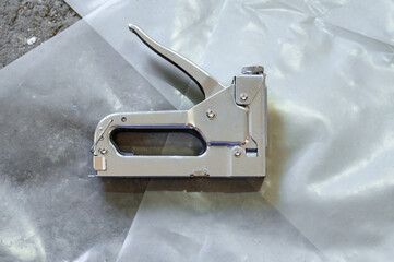 Stapler for repair and construction work, working tool close up.