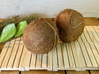 There is a coconut on the oak table © Józef