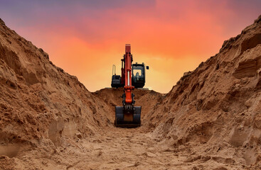 Excavator dig trench on sunset background. Backgoe on earthwork. Construction natural gas pipeline. Construction the sewage and drainage.  Laying sewer pipes at construction site. Open pit mining. - obrazy, fototapety, plakaty