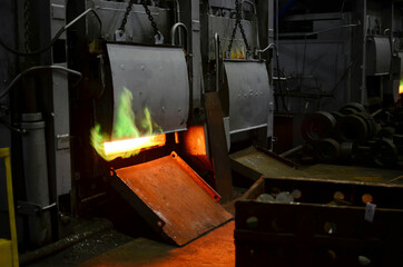 Industrial furnace in workshop of a forging plant for hardening steel at high temperature. Blacksmith and metallurgical industry, steelmaking, hot rolling mill. Heat treating. Shop in steel factory