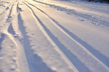 Fototapeta na wymiar Snowy road after snowfall in winter season. Snow background. Off-road snow in winter time.