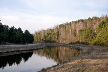 View of a small river in spring. Channel of the Vileyka-Minsk water system for the transfer of water flow
