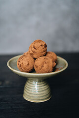 Pieces of chocolate with sweets truffle on a dark background.