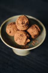 Pieces of chocolate with sweets truffle on a dark background.