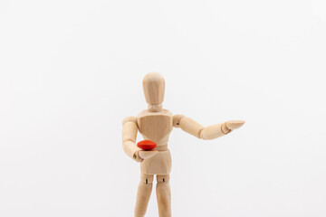 Wooden mannequin with pills on white background. Concept of pharmaceuticals and supplements.