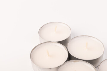 Many wax candles together on the white background