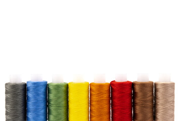 Color sewing threads isolated on white background. Different colors.Bright bobbin thread.