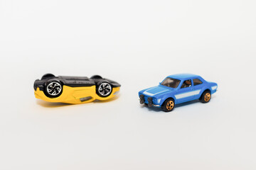Car crash between a yellow car and a blue car.Close up two car accident scene. Travel, Transport and Accident concept. white background.Copy space.soft focus.