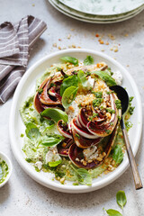 roasted radicchio salad with feta, green tahini, Pine nuts and basil pesto. Radicchio rosso di treviso tardivo, italian red chicory. Healthy Meal recipe preparation. Plant-based dishes.