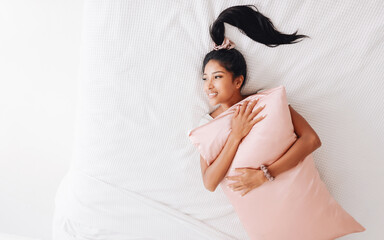 Beautiful Asian Indonesian Girl with Silk Pillow.