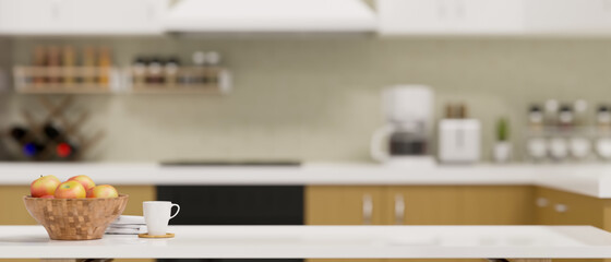 Modern dining table with copy space over blurred kitchen in background.