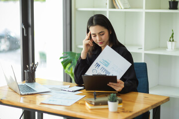 Stressed female financial consultant examines the company financial report.