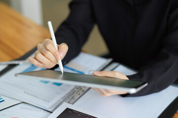 Businesswoman using stylus pen and wireless tablet computer