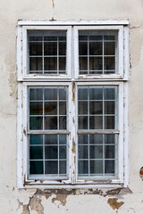 Old, vintage window with ruined and worn facade