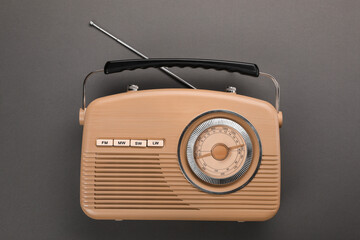 Retro radio receiver on grey background, top view
