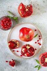 Pomegranates on a gray table top view